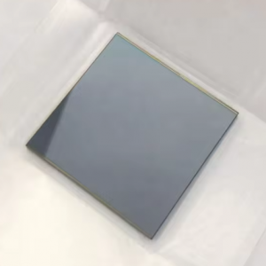 A square object on a white surface Description automatically generated